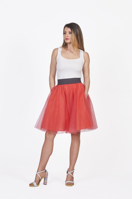 A chic ensemble featuring the mini red tulle skirt with pockets, showcasing its fashionable practicality."