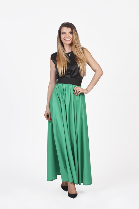 A woman wearing a long forest green skirt, exuding elegance and style. Best long green skirt for a fashionable look.